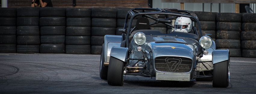 Titanium grey Caterham CSR cornering on circuit